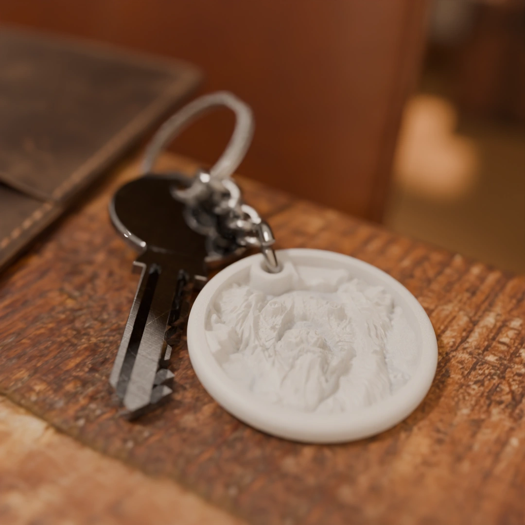 Glimery round photo keychain with a dog portrait, lying on a table, showing the relief of the photo.