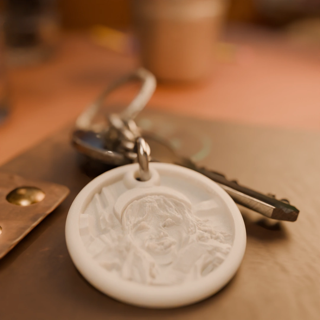 Glimery round photo keychain with a child’s portrait, lying on a table, showing the relief of the photo.